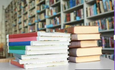 image showing books laying on table following static equilibrium